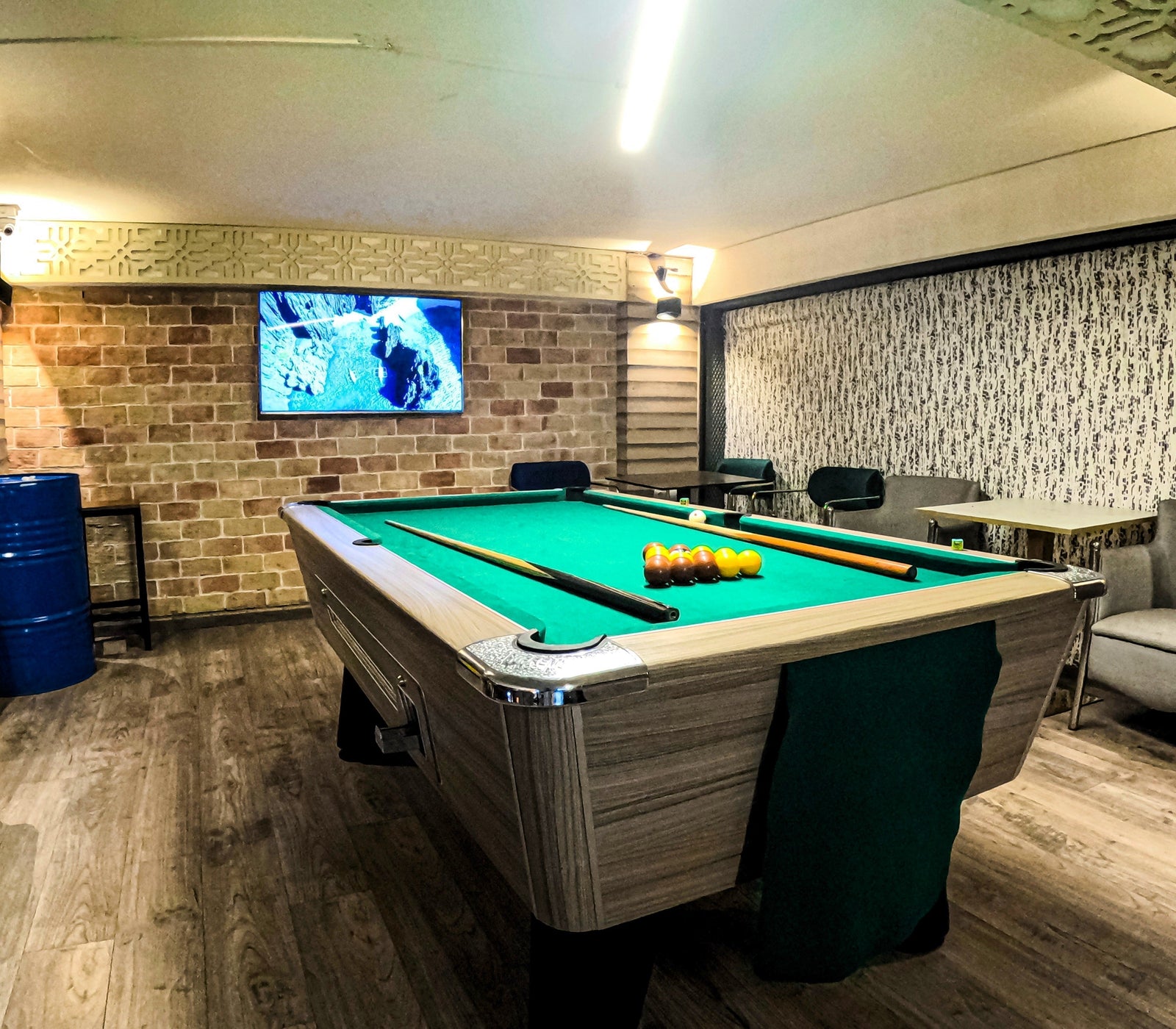 Green Billiard Table in a Well Lit Room