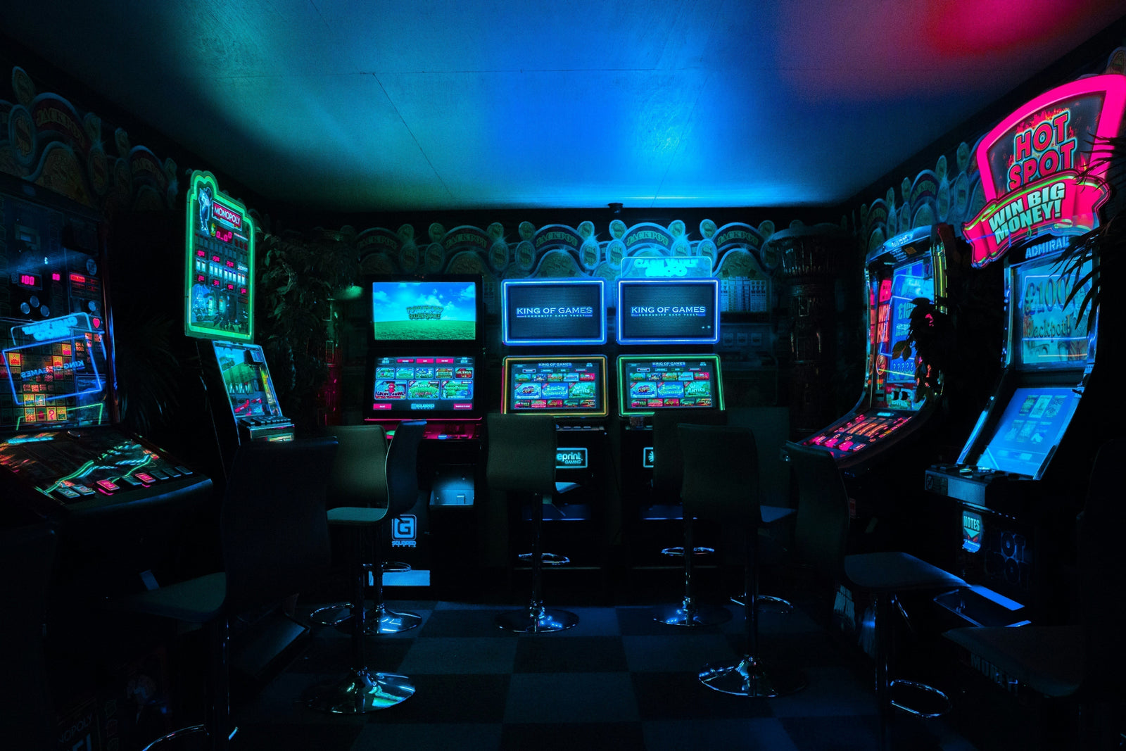 Retro Arcade Machines in a Dim Lit Room
