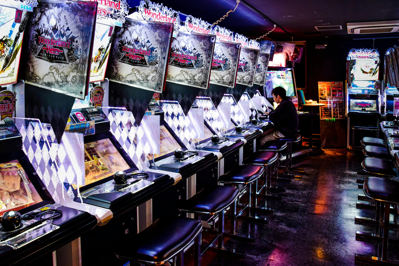 Arcade Machines with Bright Lights and a Player