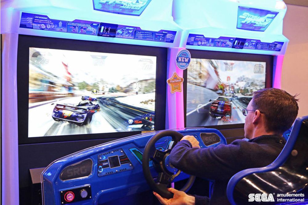 a photo showing a player enjoying the racing arcade game with vibrant monitor
