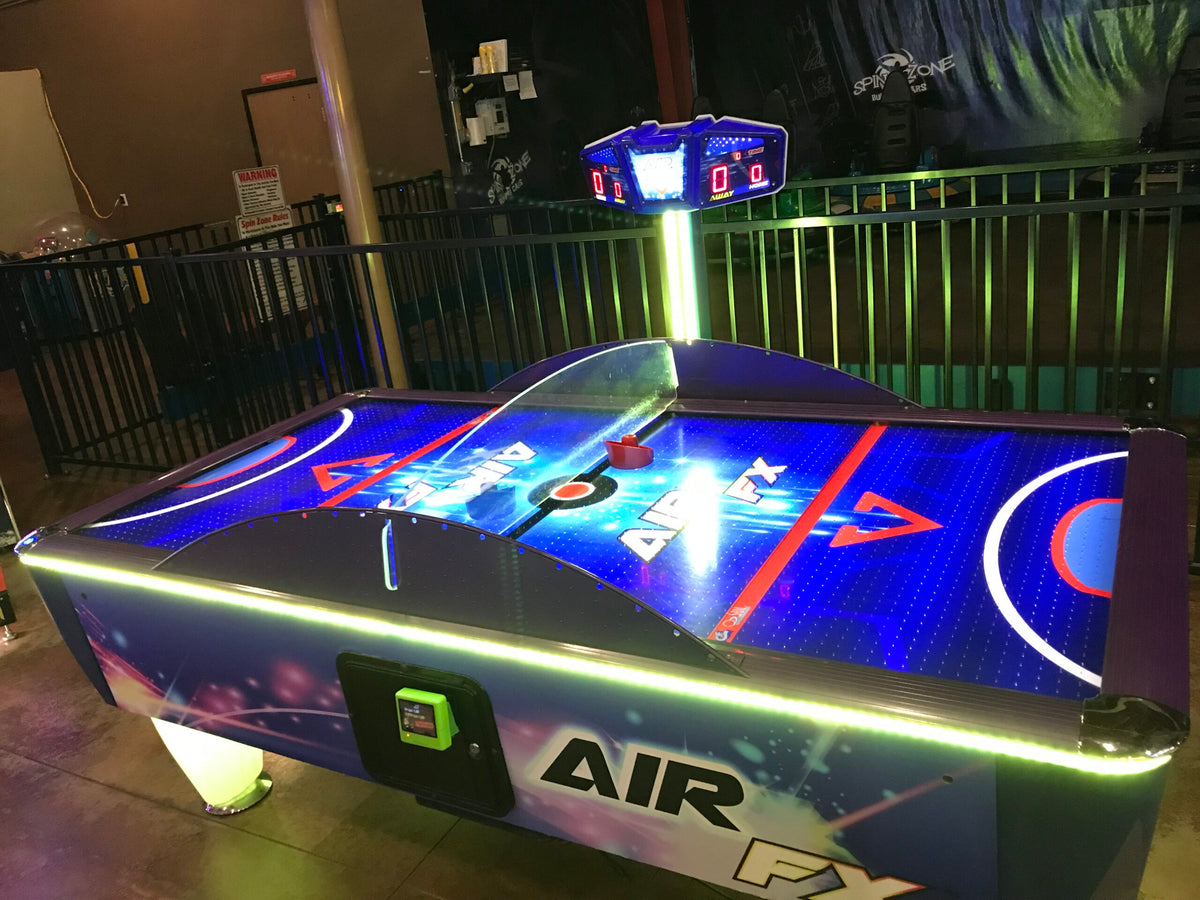 Air FX full-size 8-foot air hockey table with LED-lit playfield and ½-inch thick commercial-grade surface.