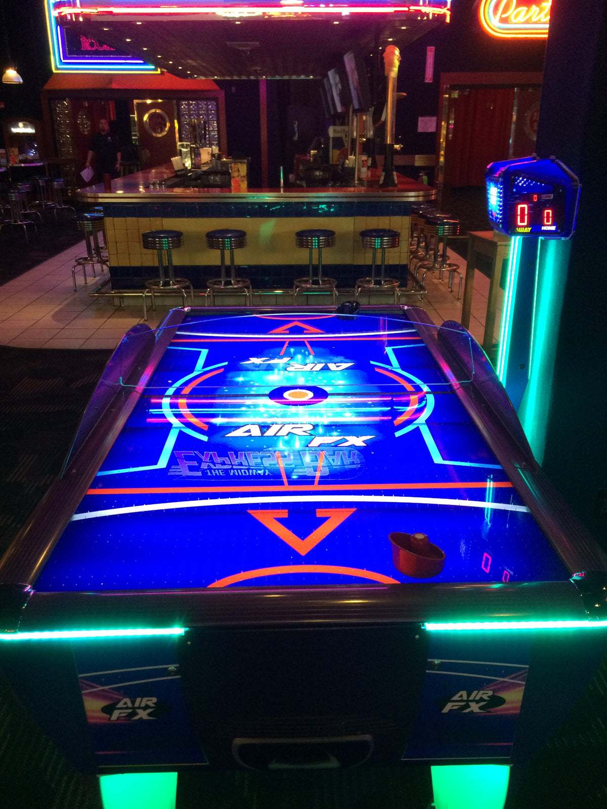 Air FX full-size 8-foot air hockey table with LED-lit playfield and ½-inch thick commercial-grade surface.