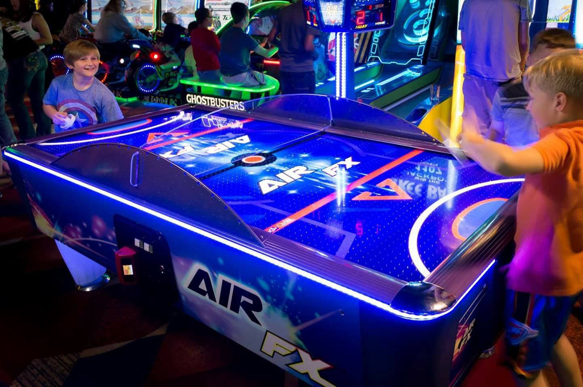Air FX full-size 8-foot air hockey table with LED-lit playfield and ½-inch thick commercial-grade surface.