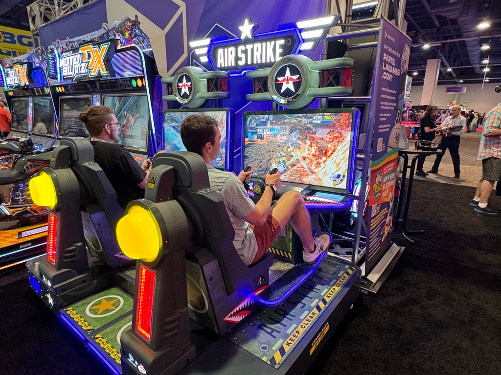 Air Strike arcade machine with 2-player flying simulator, pendulum motion seats, and optional ticket redemption.