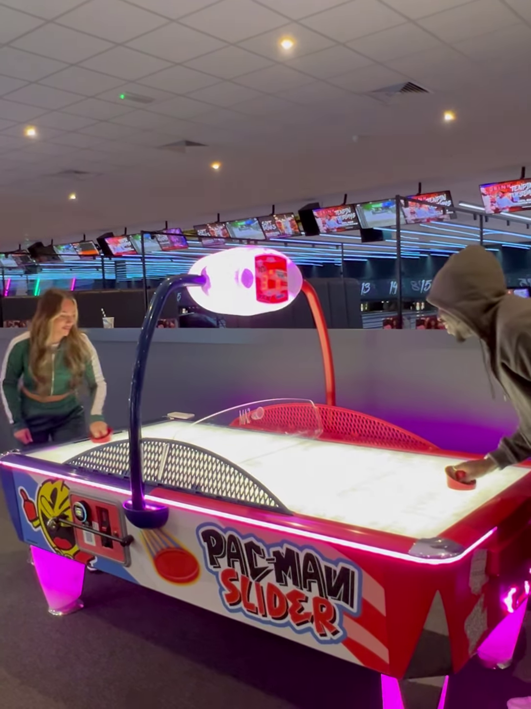 Pac-Man Slider air hockey table with LED color-changing playfield, classic Pac-Man sounds, and durable coin-operated design.
