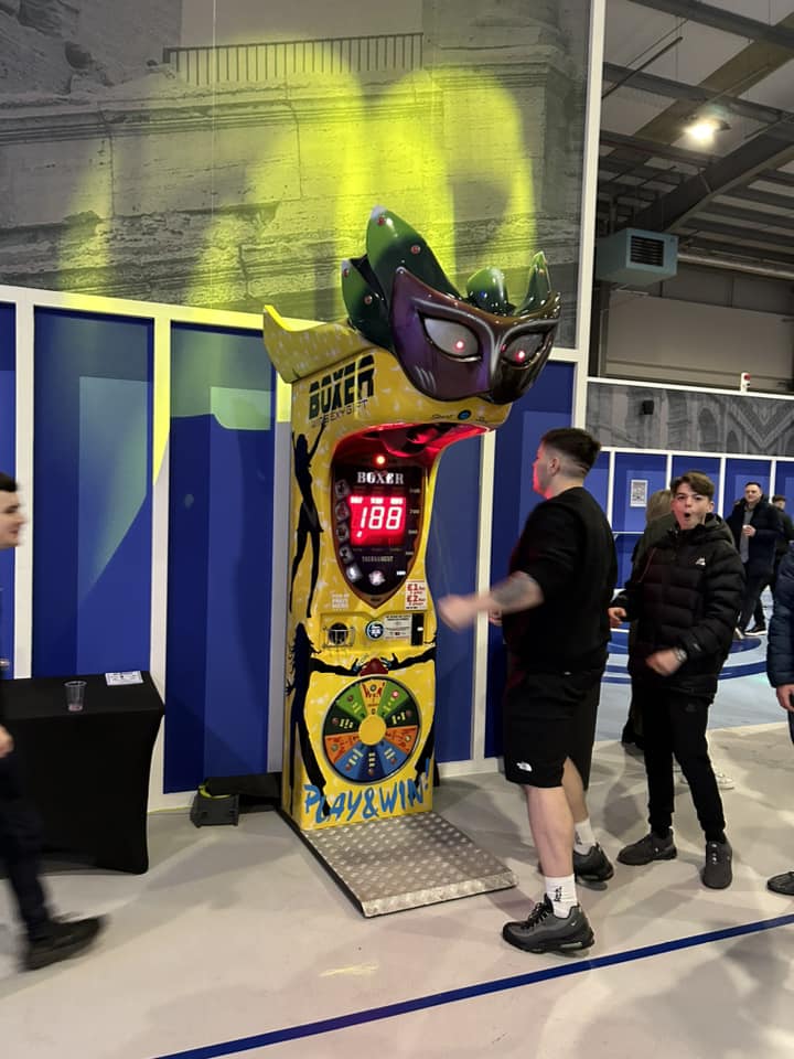 Boxer Mask redemption boxing machine with Venetian mask design and prize capsule dispenser.