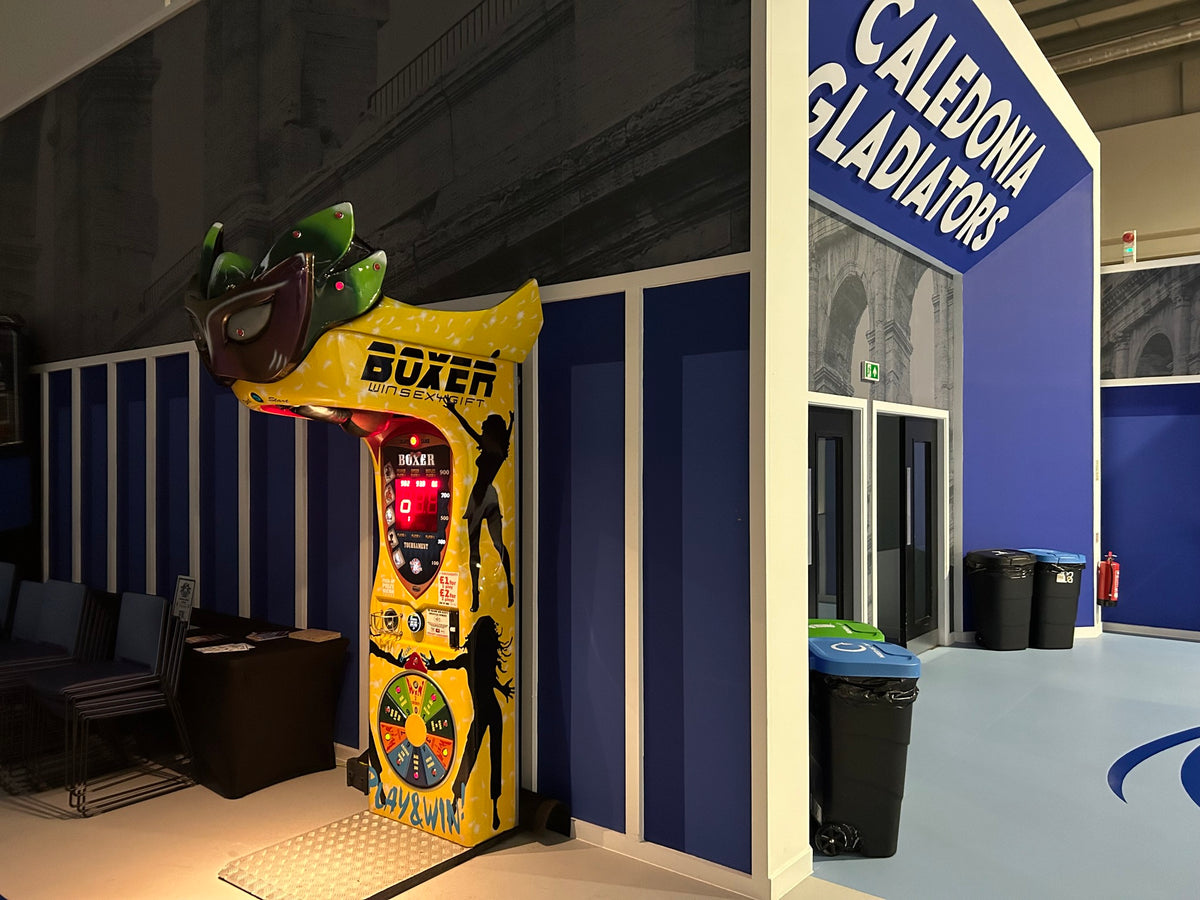 Boxer Mask redemption boxing machine with Venetian mask design and prize capsule dispenser.