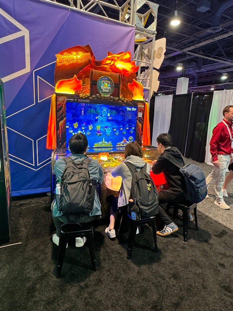 Dragon’s Bane 3-player coin pusher arcade machine with dragon-themed design and mixed analog-digital gameplay.