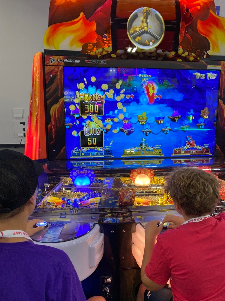 Dragon’s Bane 3-player coin pusher arcade machine with dragon-themed design and mixed analog-digital gameplay.