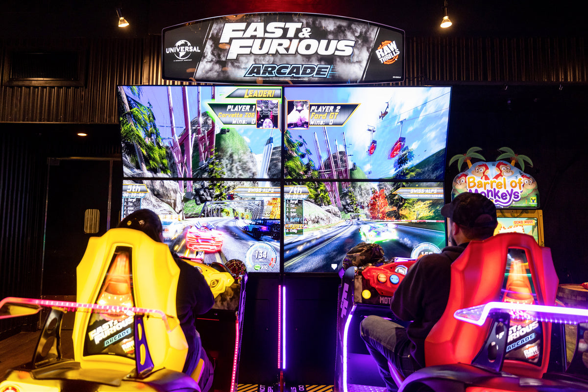 Fast & Furious Thrill-D motion racing arcade machine with dual 65-inch UHD screens, motion simulator, and 1–8 player linked cabinets