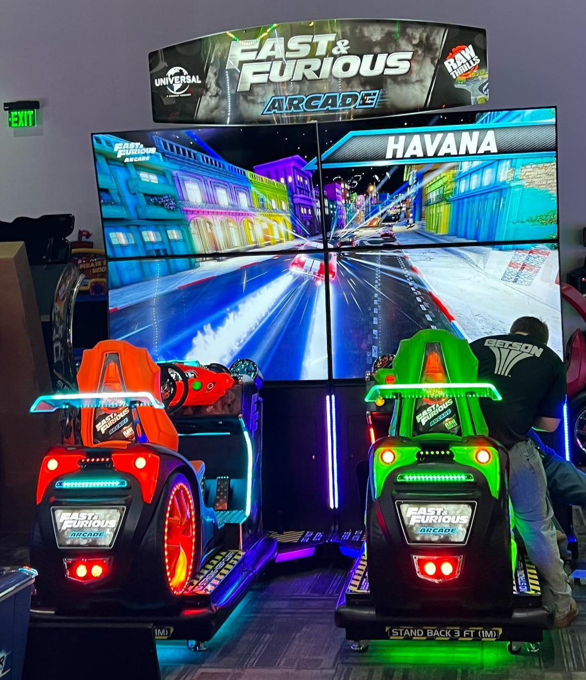 Fast & Furious Thrill-D motion racing arcade machine with dual 65-inch UHD screens, motion simulator, and 1–8 player linked cabinets