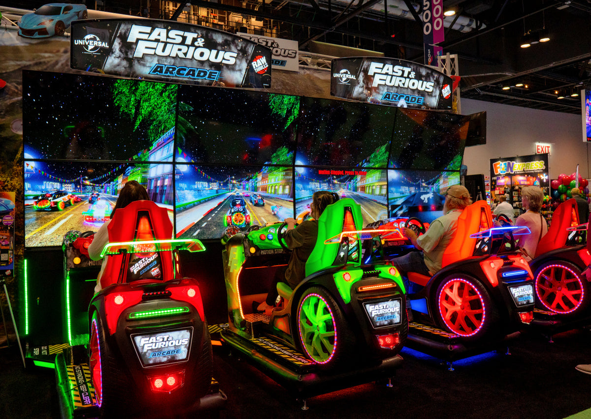 Fast & Furious Thrill-D motion racing arcade machine with dual 65-inch UHD screens, motion simulator, and 1–8 player linked cabinets
