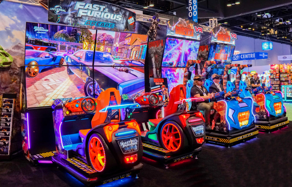 Fast & Furious Thrill-D motion racing arcade machine with dual 65-inch UHD screens, motion simulator, and 1–8 player linked cabinets