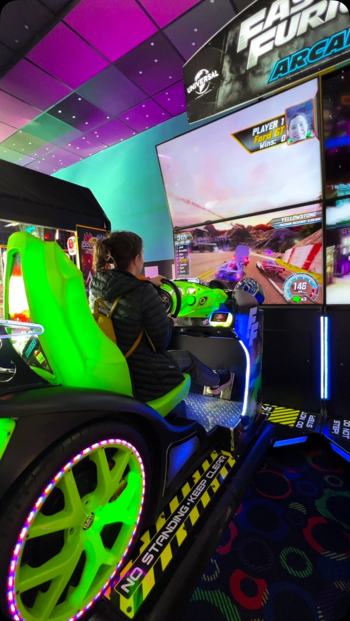 Fast & Furious Thrill-D motion racing arcade machine with dual 65-inch UHD screens, motion simulator, and 1–8 player linked cabinets