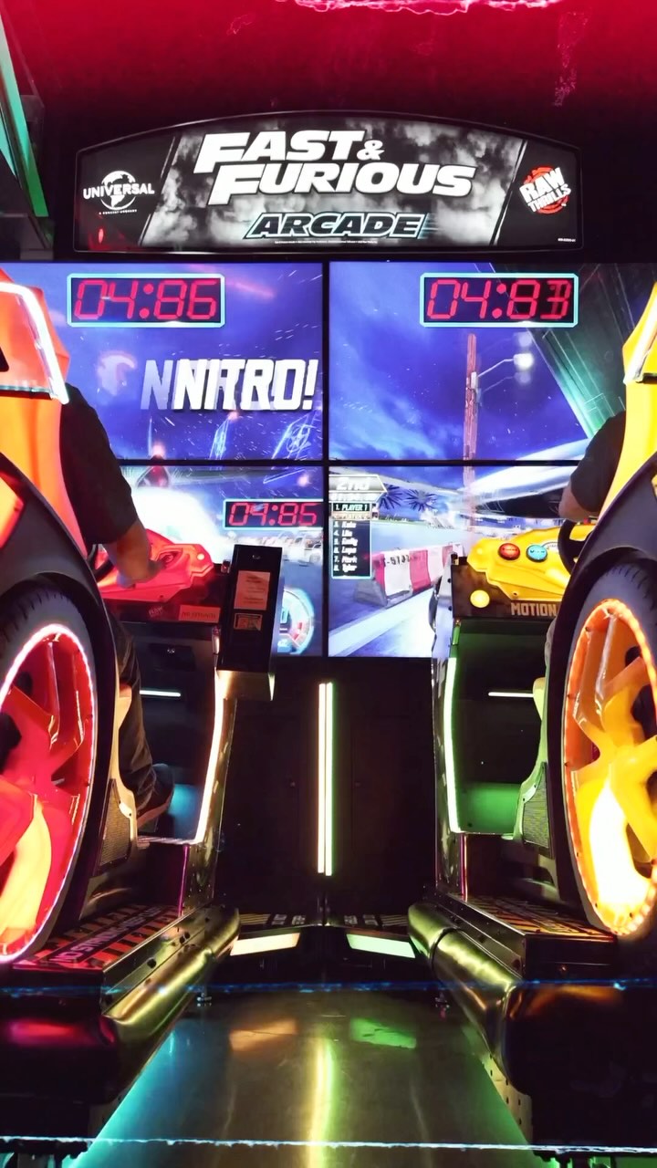 Fast & Furious Thrill-D motion racing arcade machine with dual 65-inch UHD screens, motion simulator, and 1–8 player linked cabinets