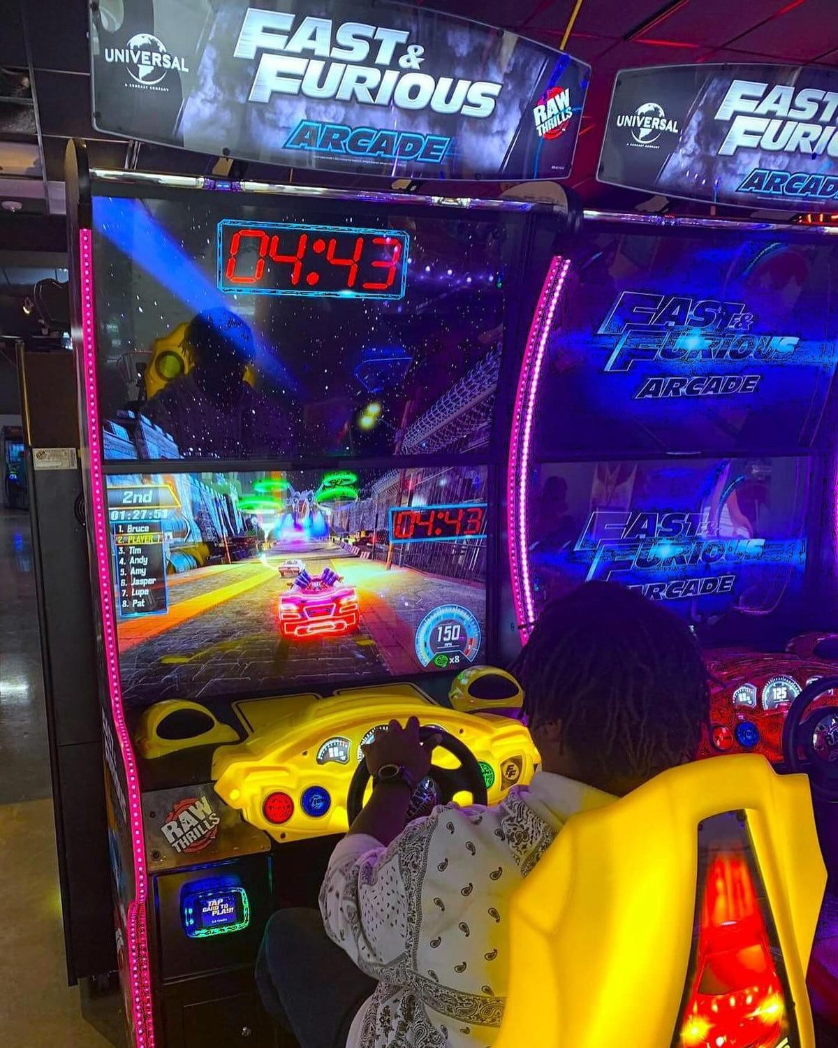 Angled view of Fast and Furious arcade racing game cabinet by Raw Thrills and Universal