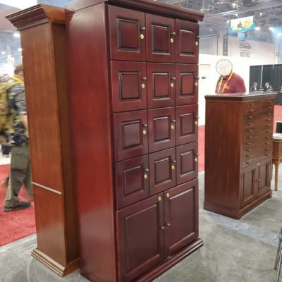 Angled view of Humidor Supreme cigar locker wall by Quality Importers with dark mahogany wood finish