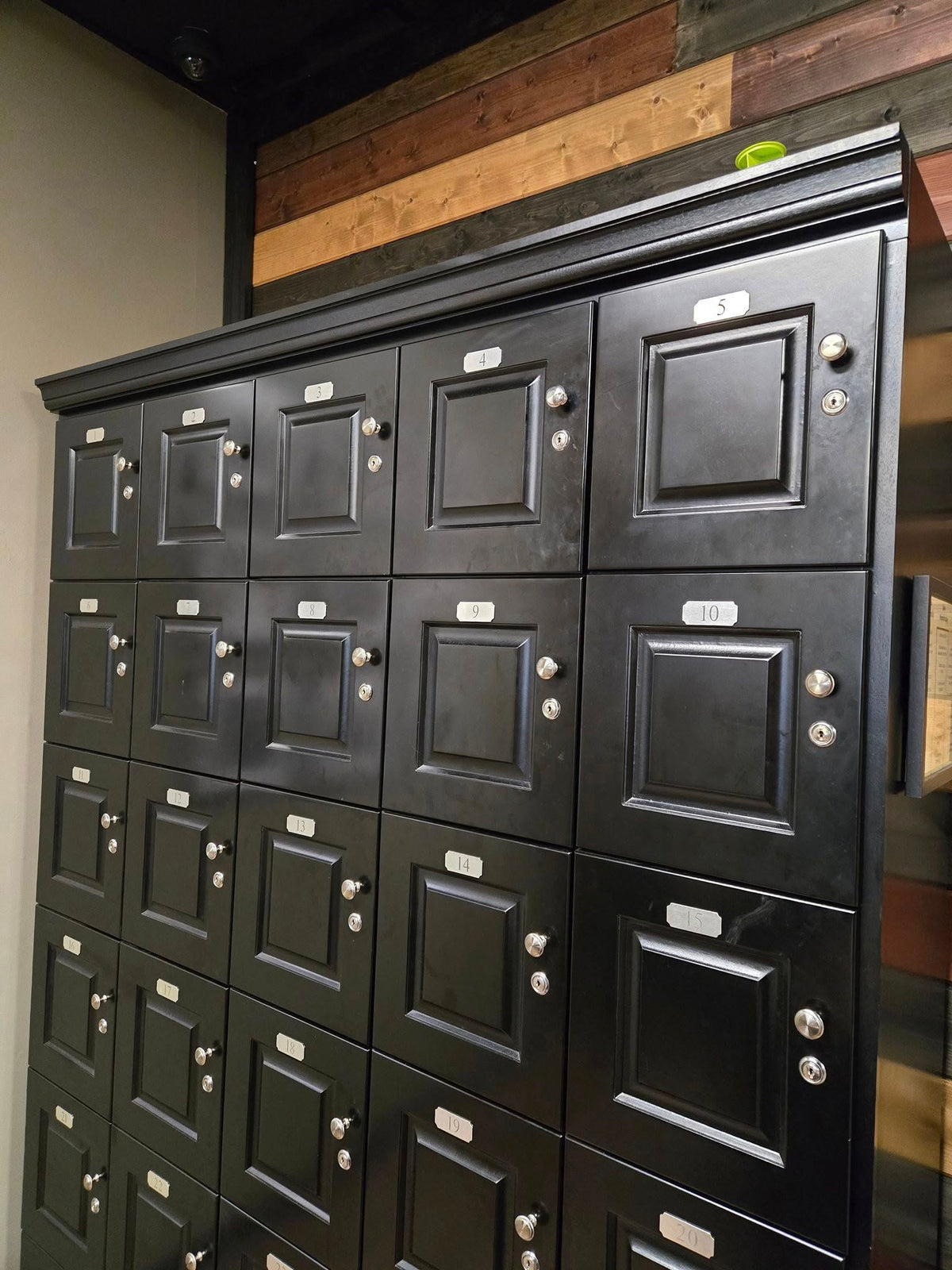 Close-up of individual cigar locker doors on 29-unit commercial humidor cabinet