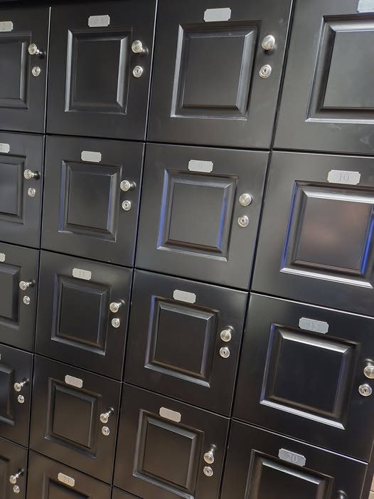 Close-up of individual cigar locker doors on 29-unit commercial humidor cabinet