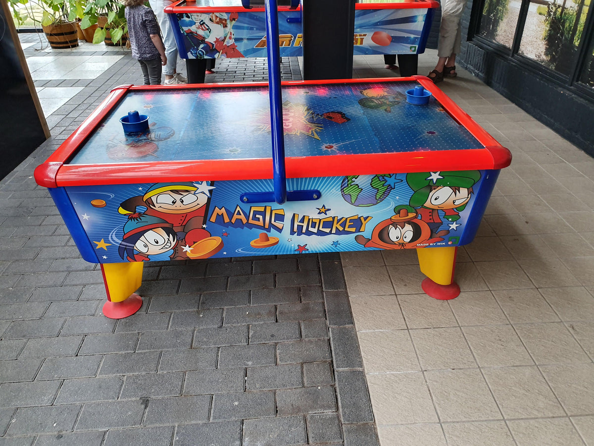 Magic Air Hockey kids table with colorful cabinet, light and sound effects for fun gameplay.