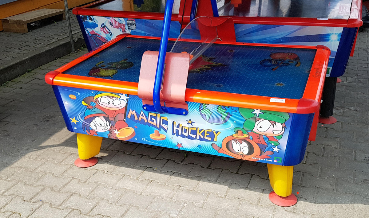 Magic Air Hockey kids table with colorful cabinet, light and sound effects for fun gameplay.