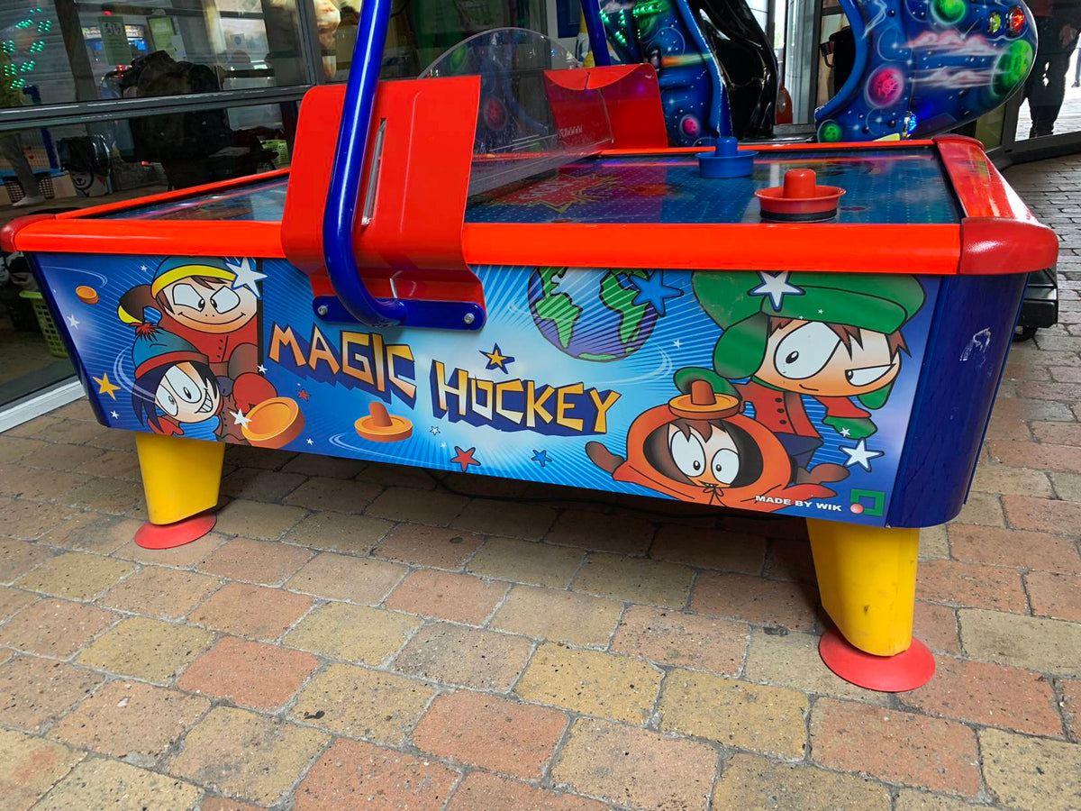 Magic Air Hockey kids table with colorful cabinet, light and sound effects for fun gameplay.