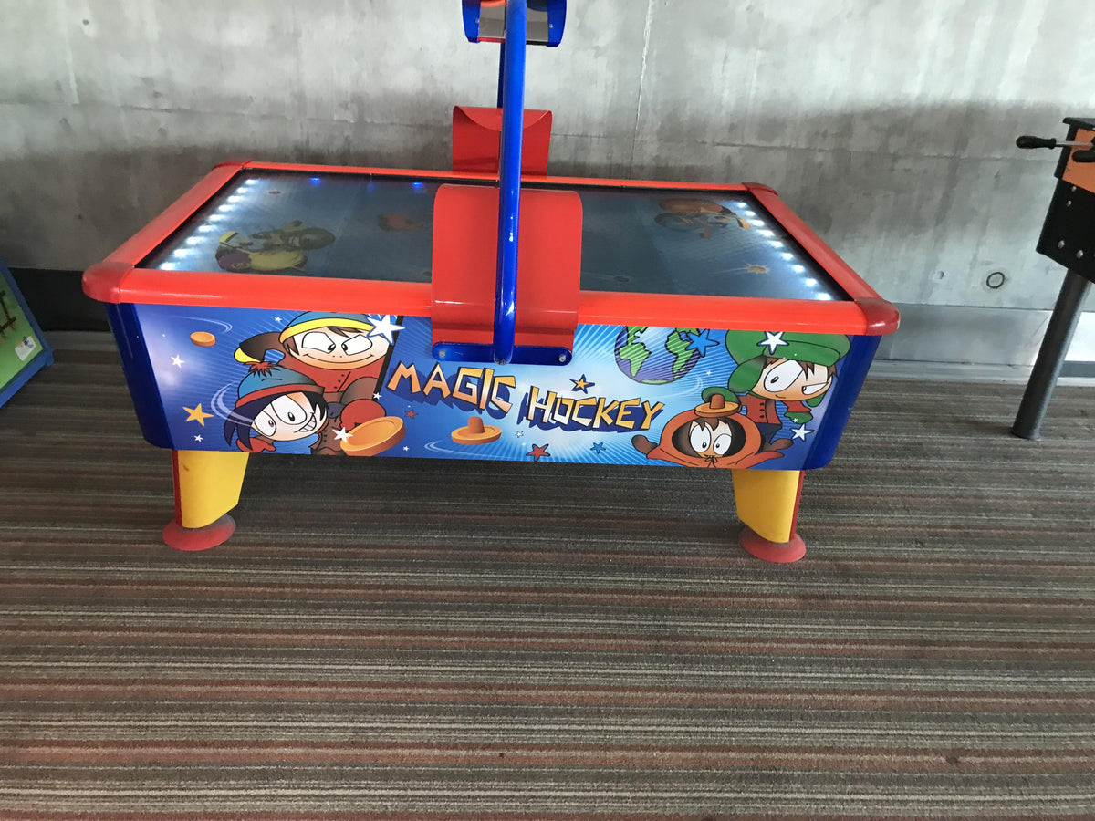 Magic Air Hockey kids table with colorful cabinet, light and sound effects for fun gameplay.