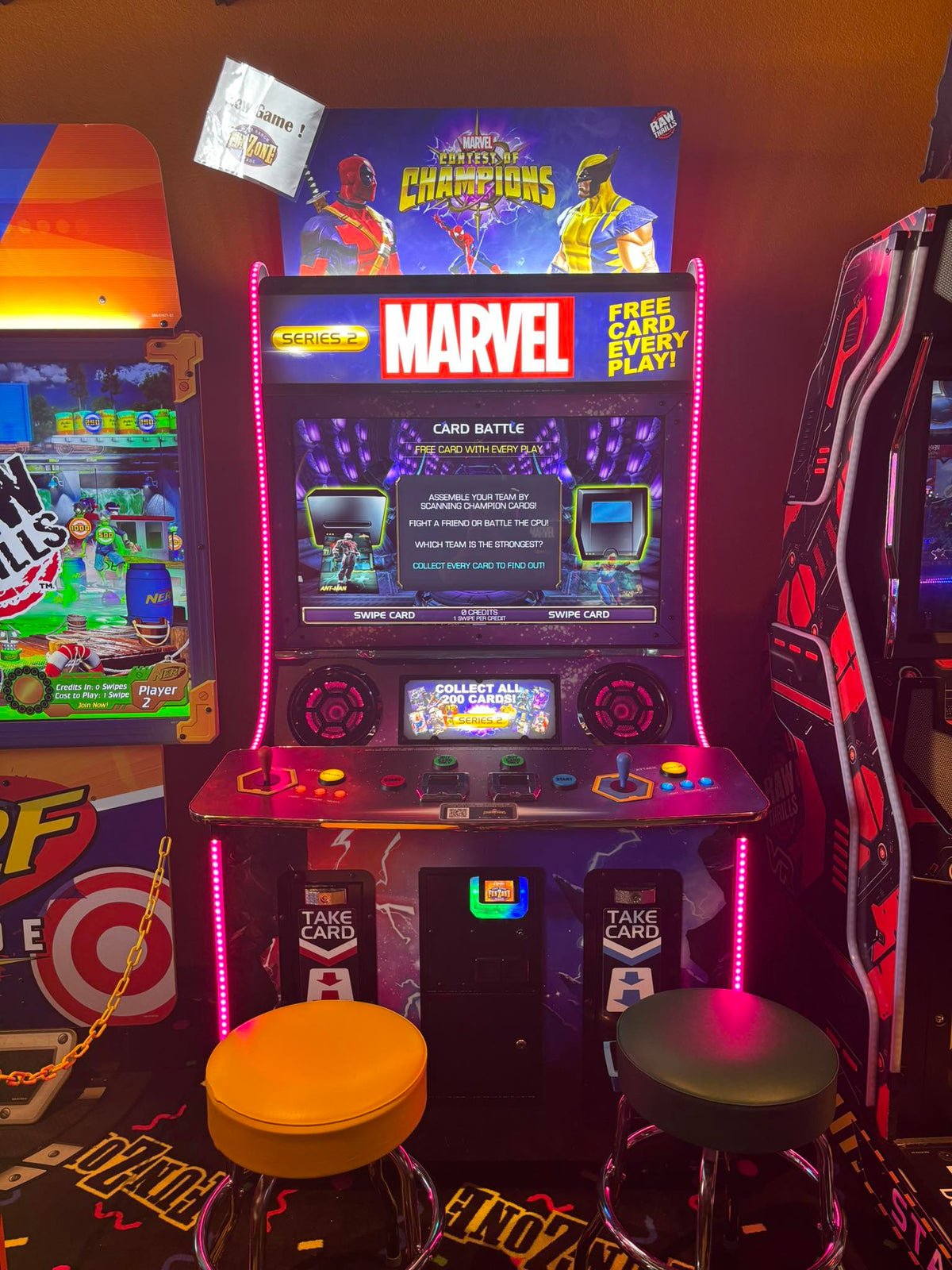 Marvel Contest of Champions arcade machine with 43-inch HD display, 2-player 3v3 fighting gameplay, and collectible champion cards.