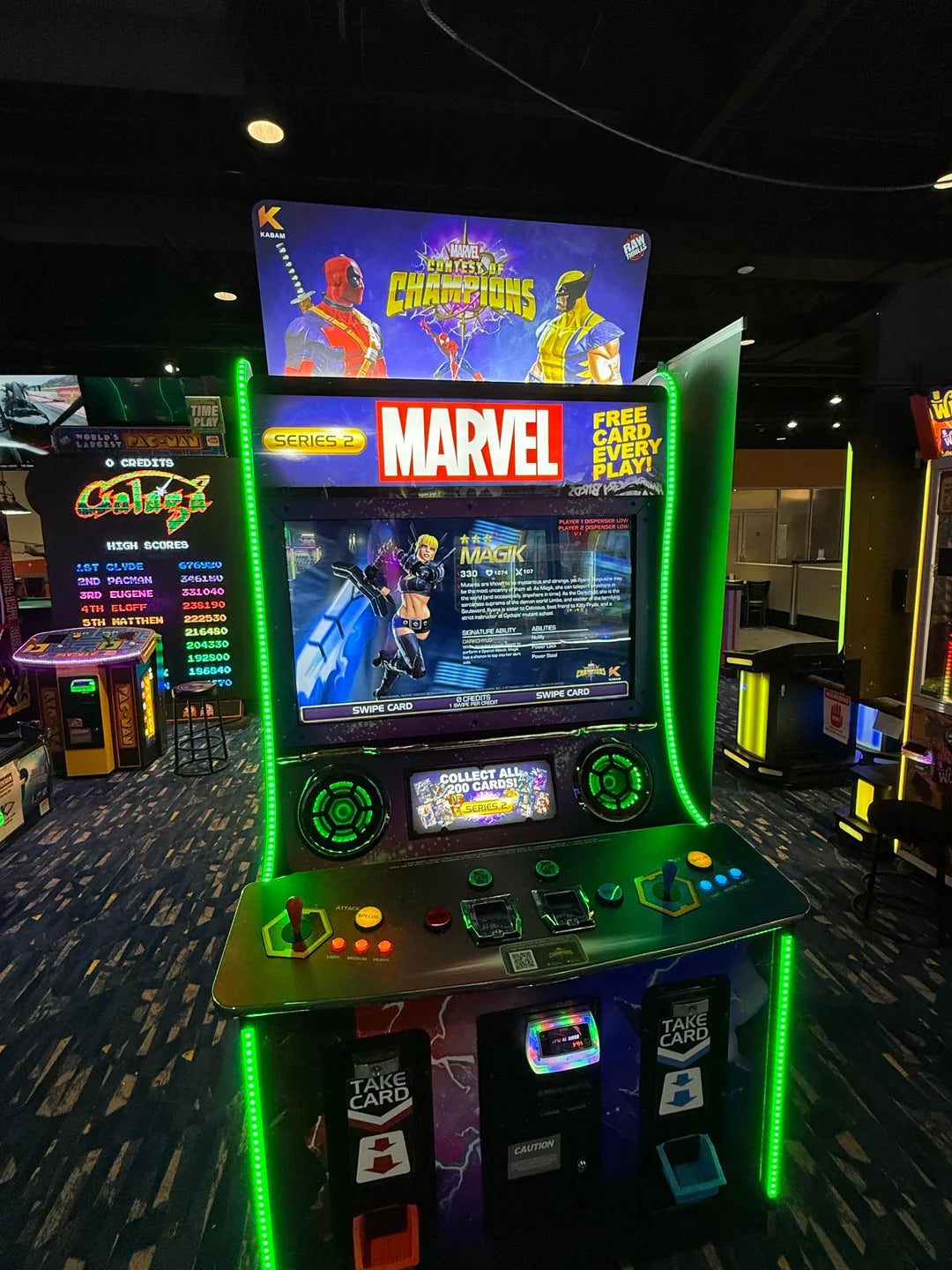 Marvel Contest of Champions arcade machine with 43-inch HD display, 2-player 3v3 fighting gameplay, and collectible champion cards.