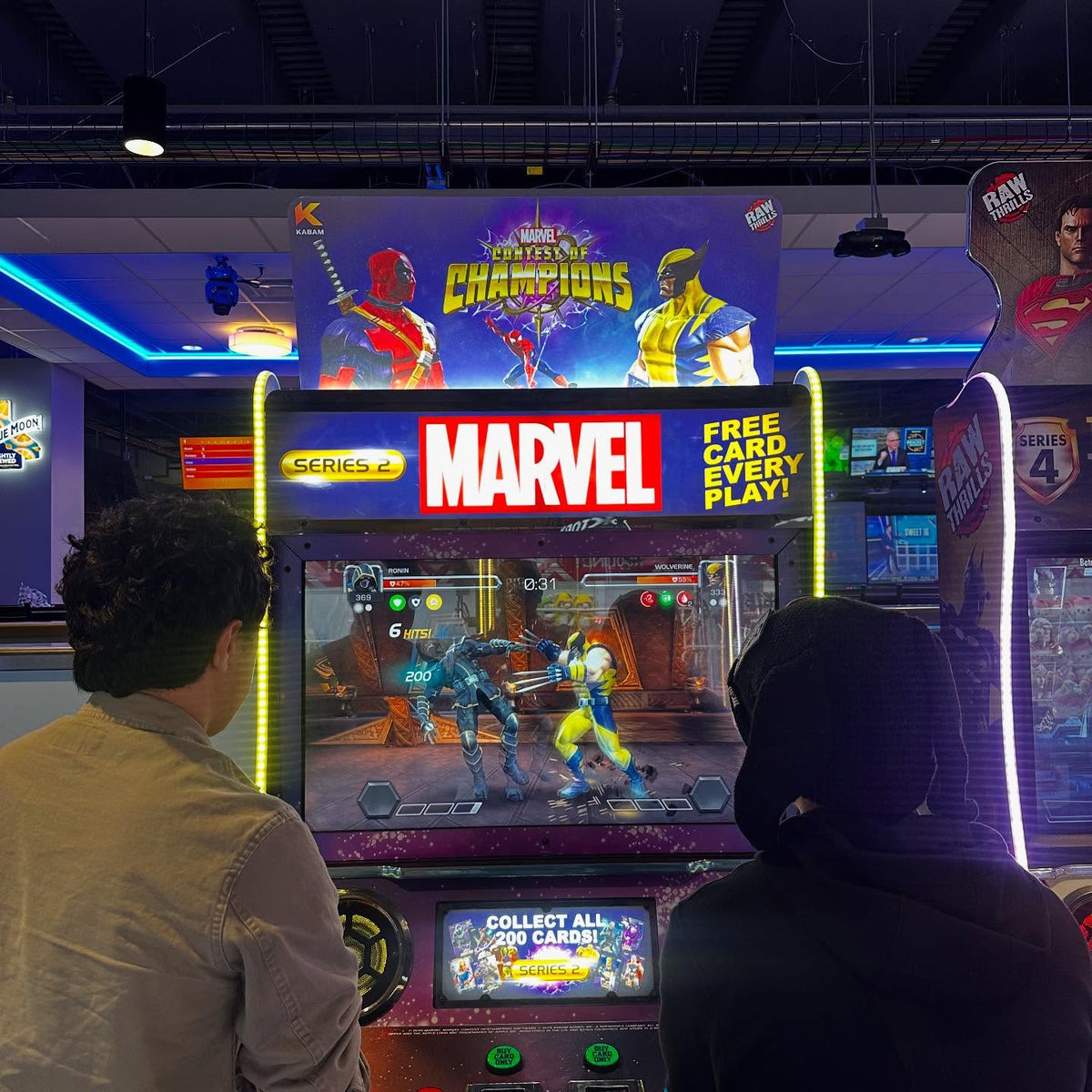 Marvel Contest of Champions arcade machine with 43-inch HD display, 2-player 3v3 fighting gameplay, and collectible champion cards.