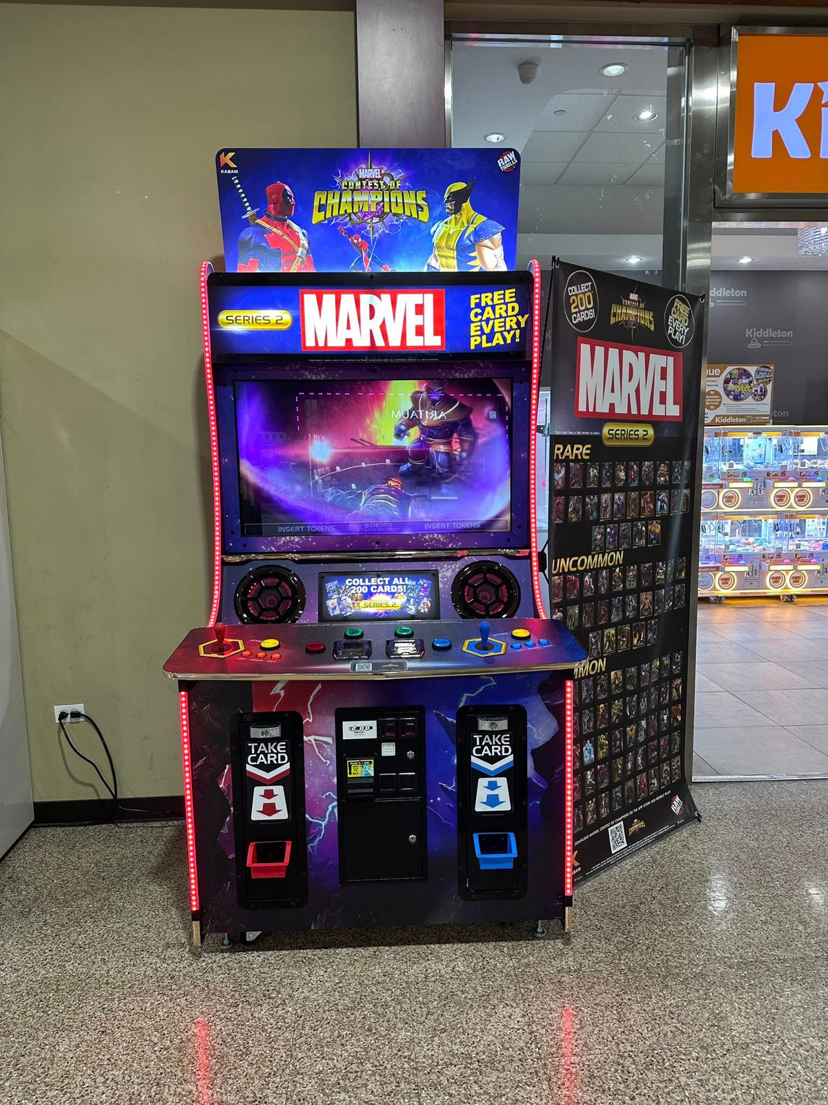 Marvel Contest of Champions arcade machine with 43-inch HD display, 2-player 3v3 fighting gameplay, and collectible champion cards.
