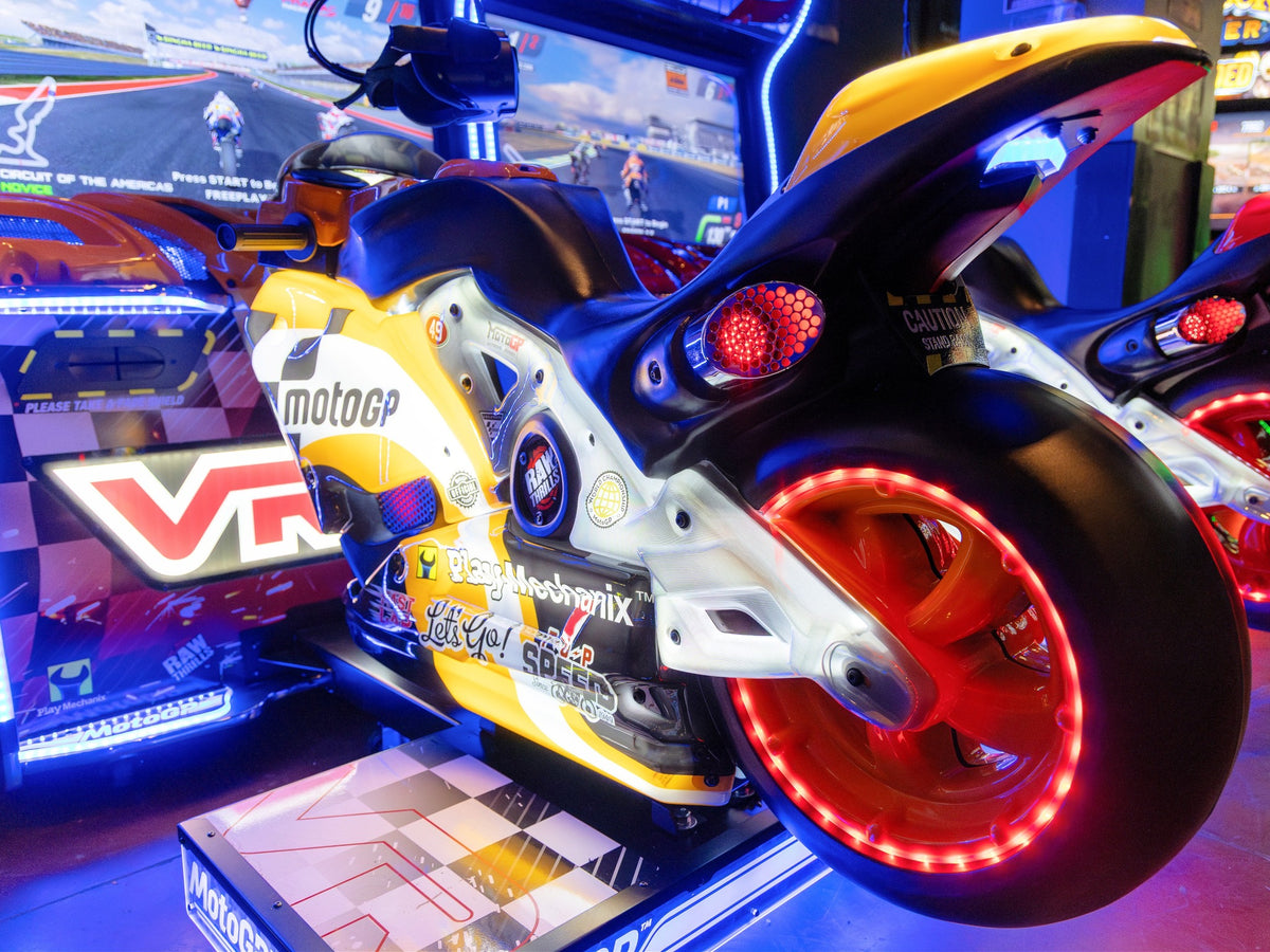 MotoGP VR arcade machine with 360° virtual reality motorcycle racing, official tracks, and HP Reverb G2 headset.