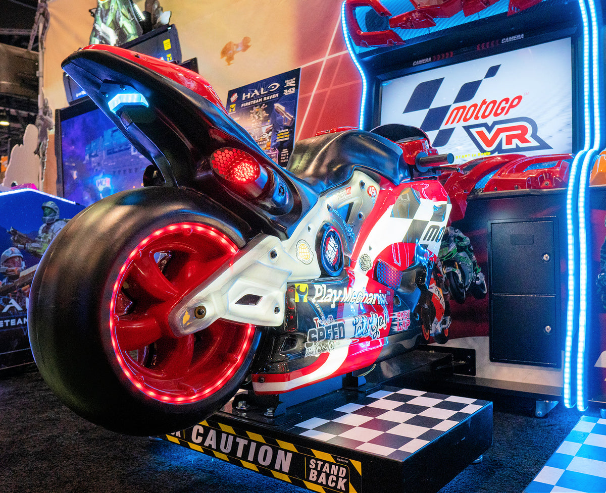 MotoGP VR arcade machine with 360° virtual reality motorcycle racing, official tracks, and HP Reverb G2 headset.