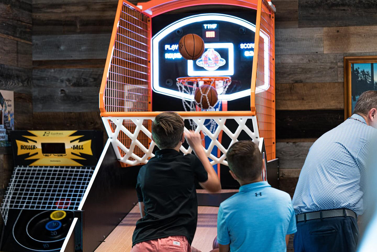 NBA Game Time Pro 8-foot basketball arcade by ICE Games with real hardwood floor, adjustable height, and 4-player Pop-A-Shot gameplay.