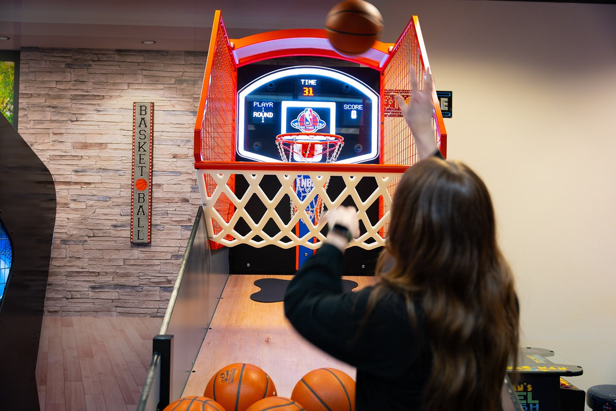 NBA Game Time Pro 8-foot basketball arcade by ICE Games with real hardwood floor, adjustable height, and 4-player Pop-A-Shot gameplay.
