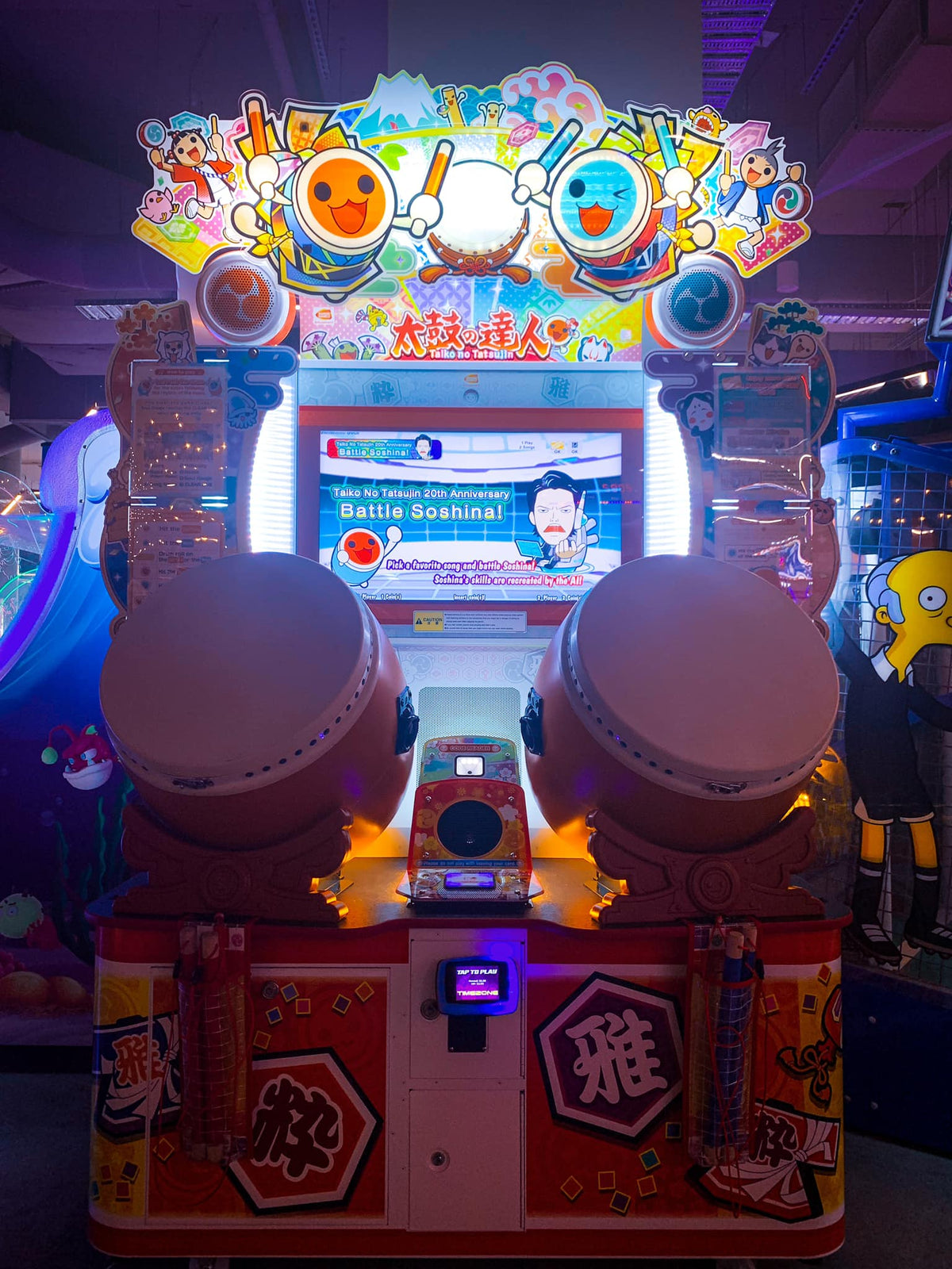 Namco Taiko No Tatsujin Drum 'N Fun arcade game with dual Taiko drums, bachi sticks, LED cabinet, and 1–2 player rhythm gameplay.