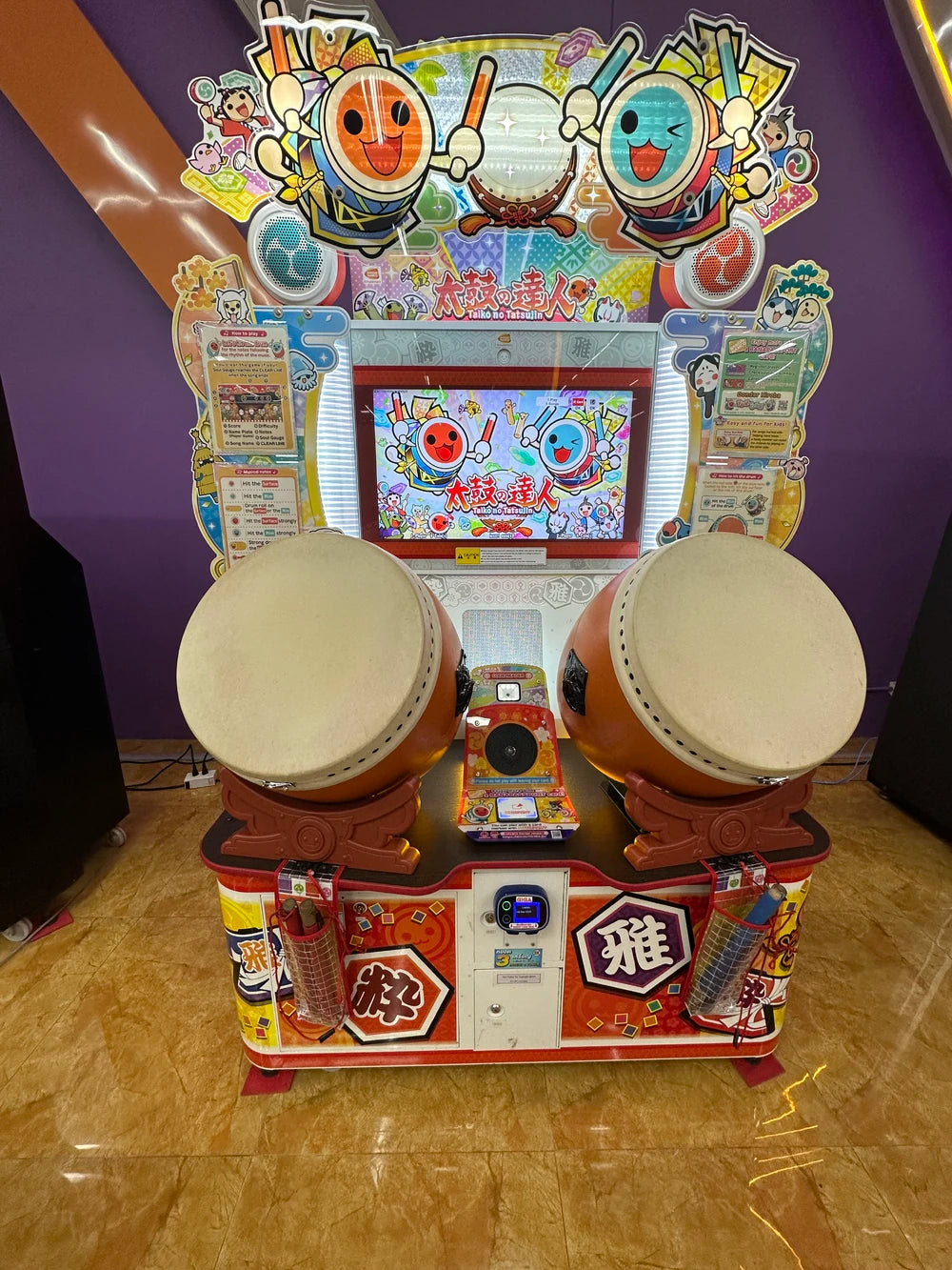 Namco Taiko No Tatsujin Drum 'N Fun arcade game with dual Taiko drums, bachi sticks, LED cabinet, and 1–2 player rhythm gameplay.