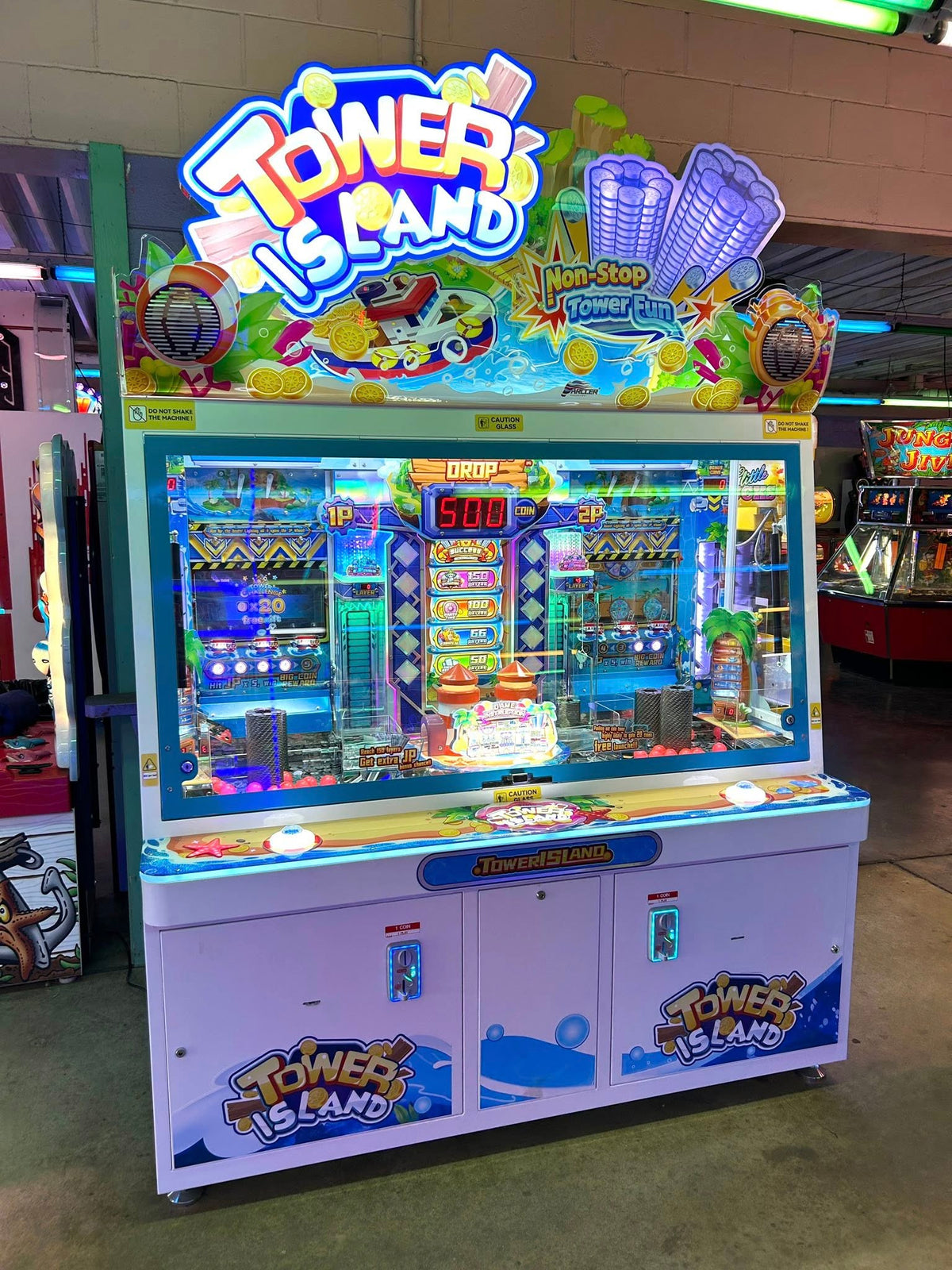 Namco Tower Island 2-player pusher arcade game with multi-level coin pusher action and LED-lit tropical cabinet.