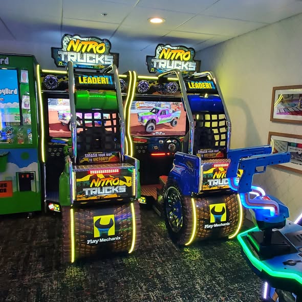 Nitro Trucks arcade machine with 43-inch HD display and force feedback steering for immersive monster truck racing.