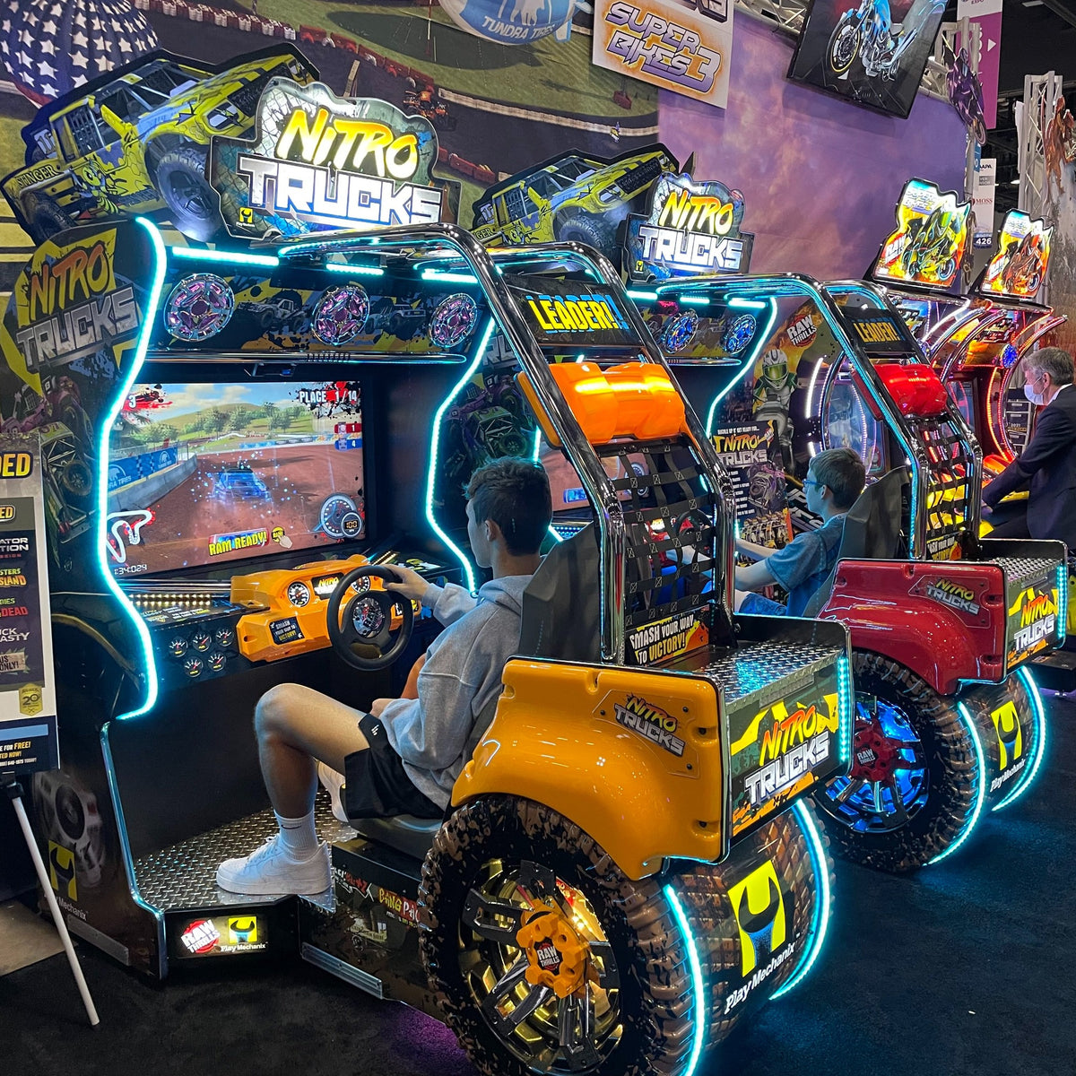 Nitro Trucks arcade machine with 43-inch HD display and force feedback steering for immersive monster truck racing.