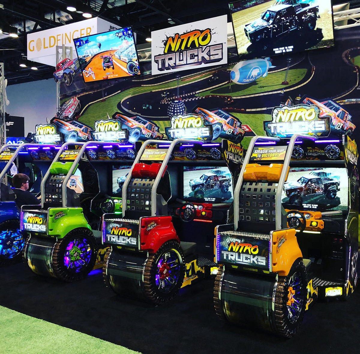Nitro Trucks arcade machine with 43-inch HD display and force feedback steering for immersive monster truck racing.
