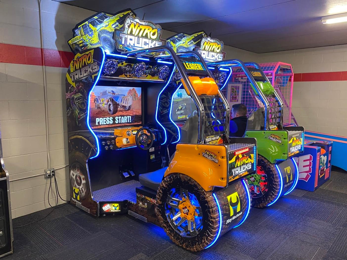 Nitro Trucks arcade machine with 43-inch HD display and force feedback steering for immersive monster truck racing.