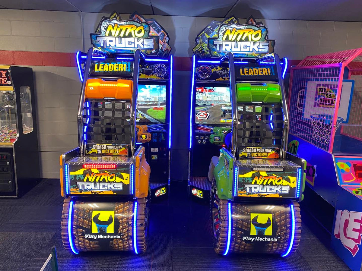 Nitro Trucks arcade machine with 43-inch HD display and force feedback steering for immersive monster truck racing.