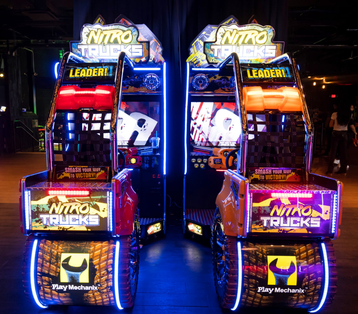 Nitro Trucks arcade machine with 43-inch HD display and force feedback steering for immersive monster truck racing.