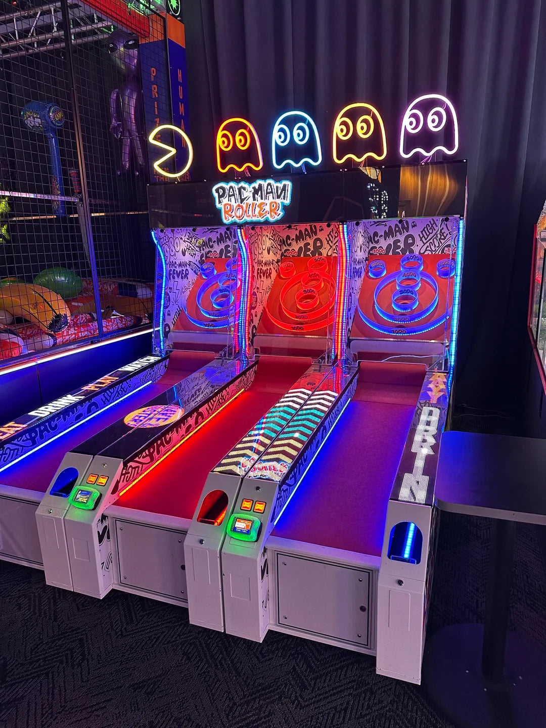 Angled view of Namco Pac-Man Roller Alley roller arcade game featuring bright LED lights and Pac-Man graphics
