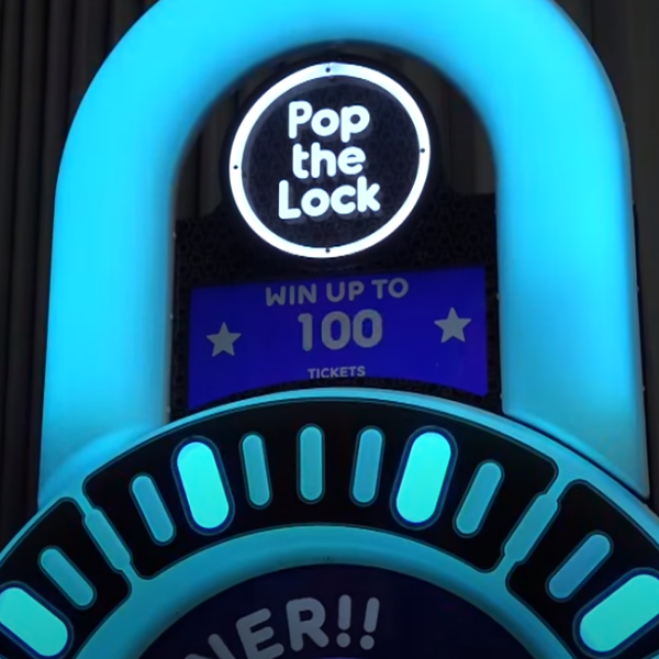 Pop the Lock arcade machine with circular LED lock display, fast-paced button timing gameplay, and bright cabinet graphics