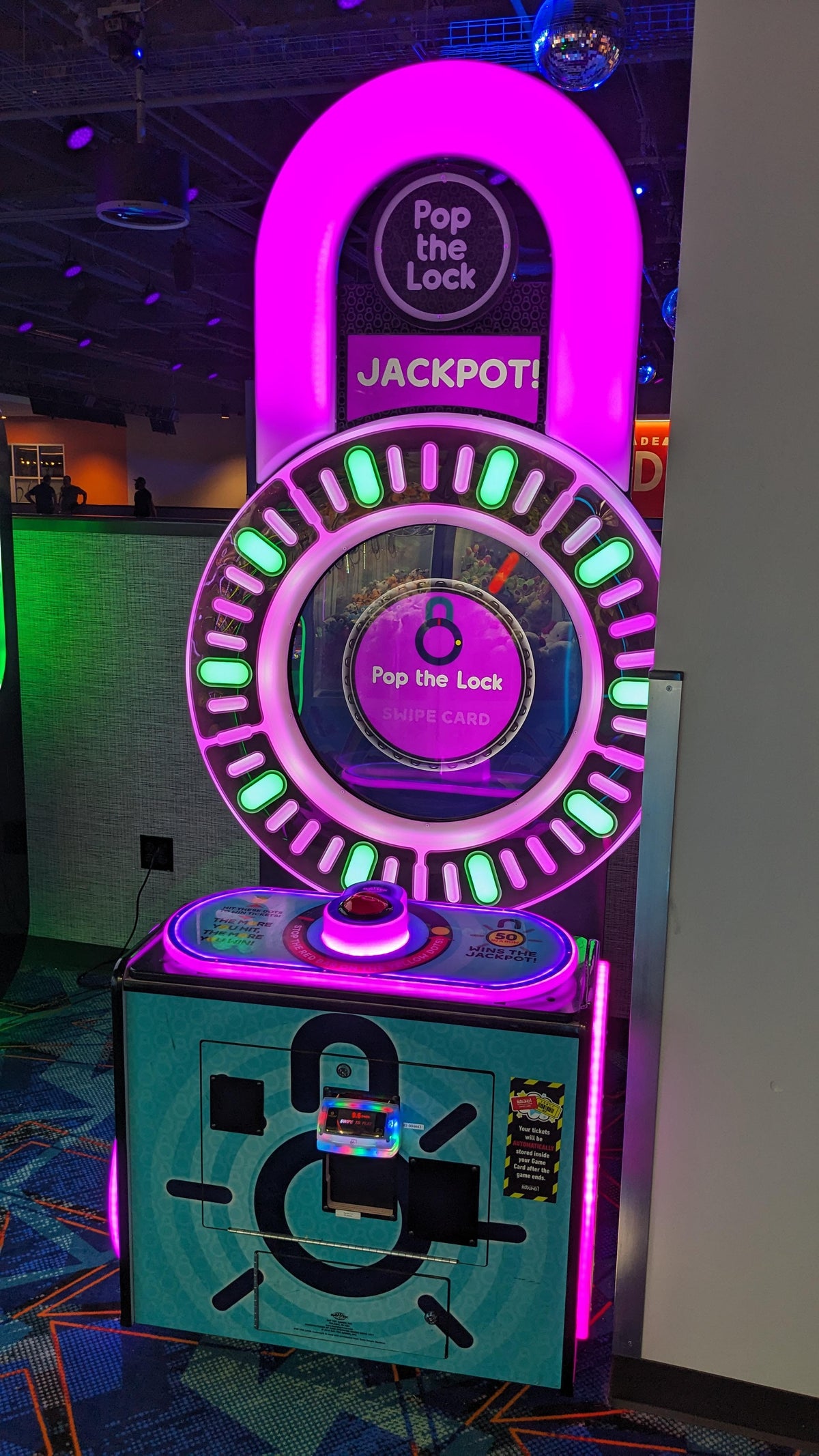 Pop the Lock arcade machine with circular LED lock display, fast-paced button timing gameplay, and bright cabinet graphics