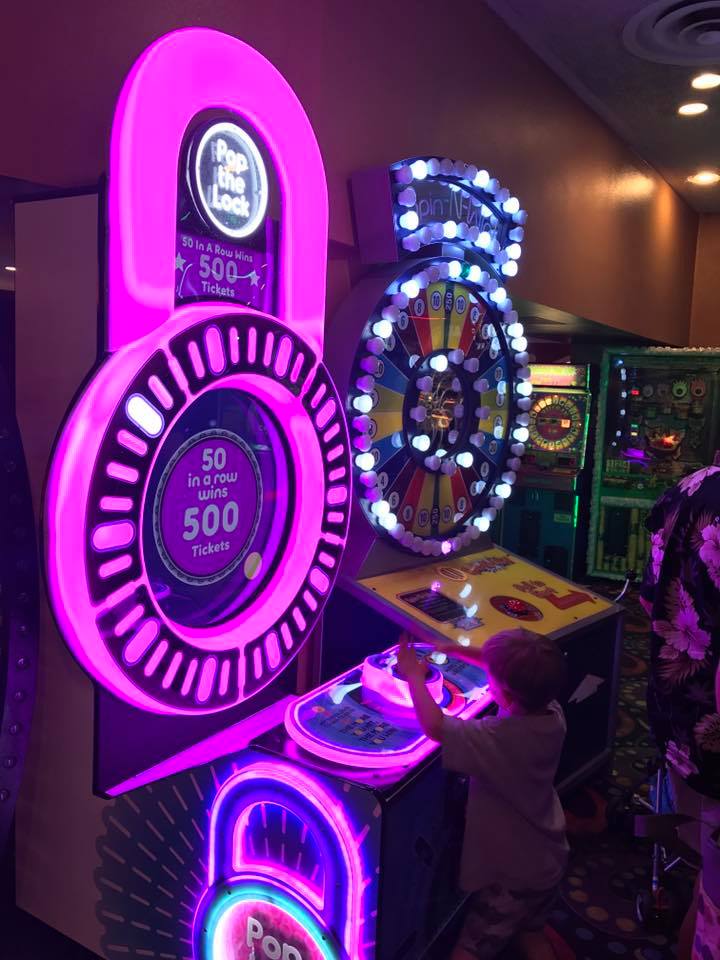 Pop the Lock arcade machine with circular LED lock display, fast-paced button timing gameplay, and bright cabinet graphics
