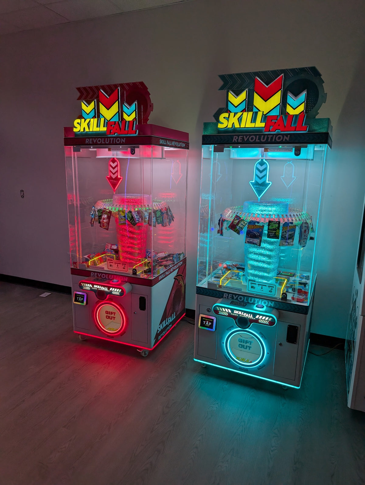 Skill Fall Revolution blue cabinet prize redemption arcade machine with vertical drop gameplay and illuminated prize compartments