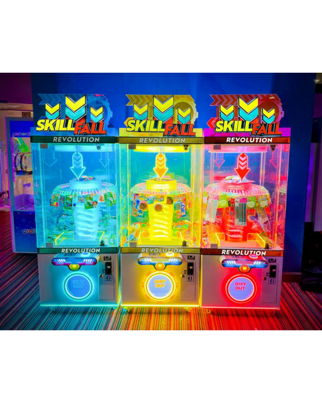 Skill Fall Revolution blue cabinet prize redemption arcade machine with vertical drop gameplay and illuminated prize compartments